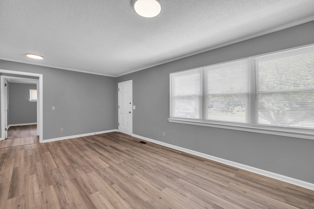 5506 Sunny Dell Ln, Chattanooga, TN 37412 - unfurnished room with a textured ceiling, plenty of natural light, wood finished floors, and ornamental molding