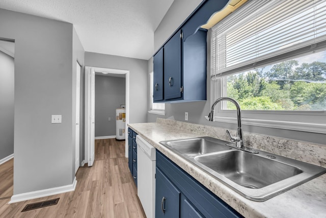 5506 Sunny Dell Ln, Chattanooga, TN 37412 - kitchen featuring blue cabinets, dishwasher, light wood-style floors, and light countertops