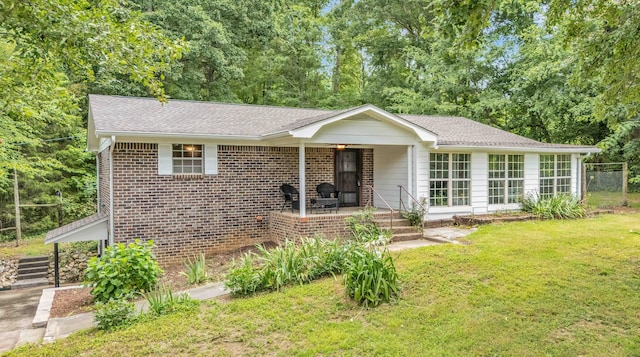 547 Van Davis Rd, Georgetown, TN 37336 - ranch-style home featuring a front lawn, a shingled roof, brick siding, and view of scattered trees
