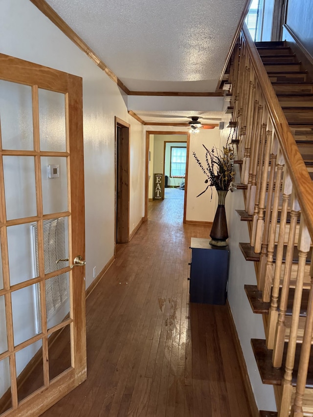 210 Laurel Ave, South Pittsburg, TN 37380 - hallway featuring crown molding, dark wood-style flooring, stairs, and a textured ceiling