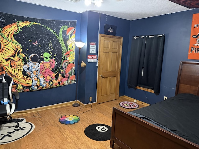 210 Laurel Ave, South Pittsburg, TN 37380 - bedroom with wood finished floors and a textured ceiling