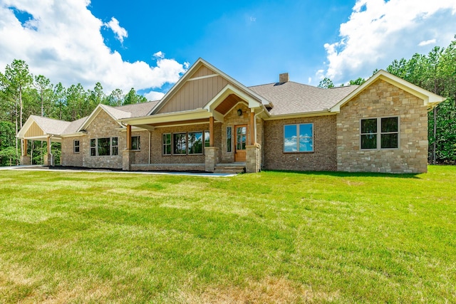 220 High Point Ln, Jasper, TN 37347 - view of front facade featuring board and batten siding, a front lawn, a chimney, stone siding, and a shingled roof