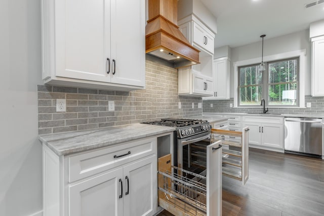 220 High Point Ln, Jasper, TN 37347 - kitchen with appliances with stainless steel finishes, custom range hood, decorative backsplash, light stone countertops, and white cabinetry