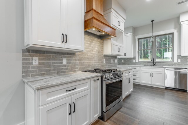 220 High Point Ln, Jasper, TN 37347 - kitchen with stainless steel appliances, custom exhaust hood, white cabinetry, light stone counters, and backsplash