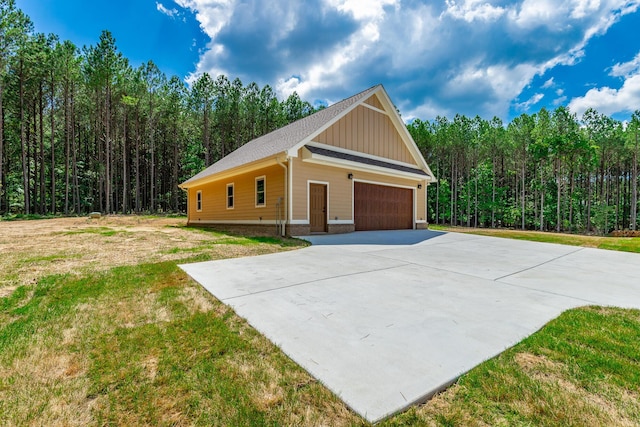 220 High Point Ln, Jasper, TN 37347 - view of front facade featuring board and batten siding, a front lawn, and a forest view