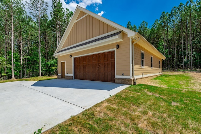 220 High Point Ln, Jasper, TN 37347 - view of property exterior with board and batten siding, a lawn, a wooded view, and a detached garage