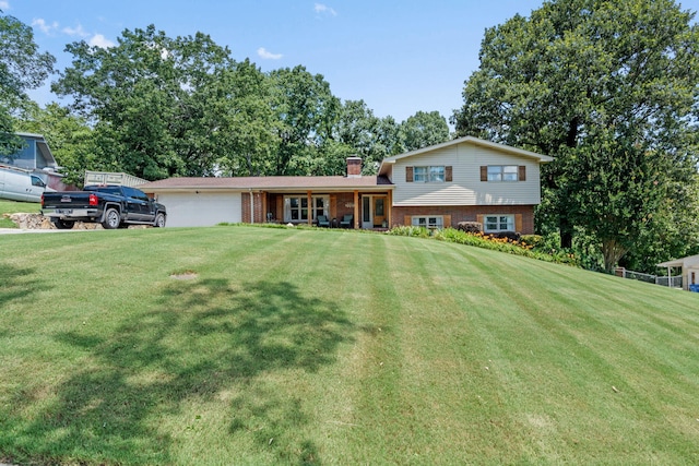 4522 Cloverdale Loop, Hixson, TN 37343 - split level home featuring brick siding, a front yard, a chimney, and a garage