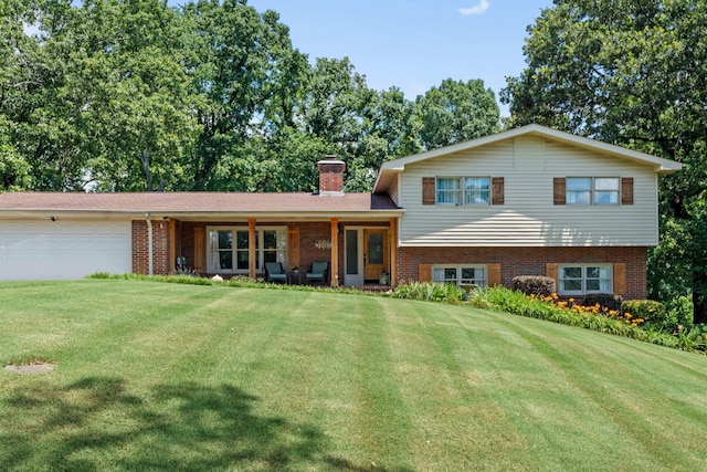 4522 Cloverdale Loop, Hixson, TN 37343 - tri-level home with brick siding, a garage, and a front yard