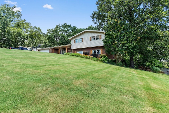 4522 Cloverdale Loop, Hixson, TN 37343 - view of front facade featuring an attached garage, a front lawn, and brick siding