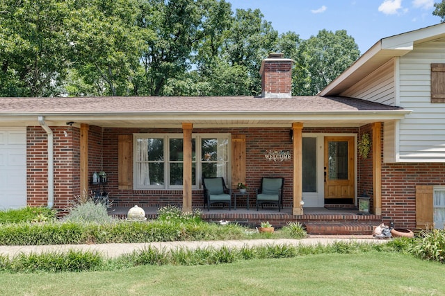 4522 Cloverdale Loop, Hixson, TN 37343 - doorway to property with brick siding, covered porch, a chimney, a garage, and a lawn