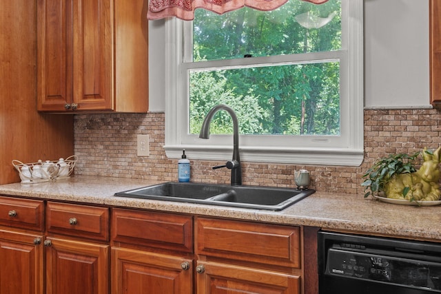 4522 Cloverdale Loop, Hixson, TN 37343 - kitchen with black dishwasher, tasteful backsplash, light countertops, and brown cabinetry