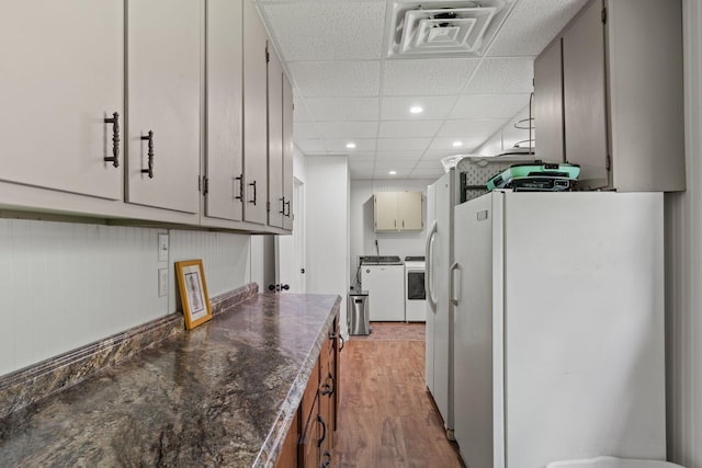 4522 Cloverdale Loop, Hixson, TN 37343 - kitchen featuring freestanding refrigerator, light wood-style flooring, dark countertops, recessed lighting, and separate washer and dryer