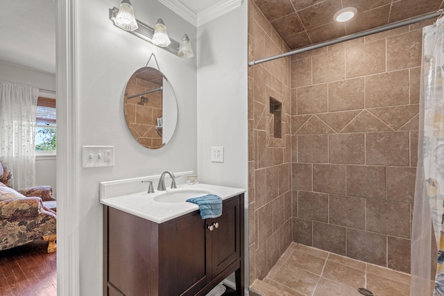 4522 Cloverdale Loop, Hixson, TN 37343 - ensuite bathroom featuring ornamental molding, vanity, a tile shower, and wood finished floors