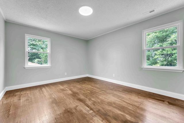 3010 Georgetown Dr NW, Cleveland, TN 37312 - spare room featuring a textured ceiling, wood finished floors, and plenty of natural light