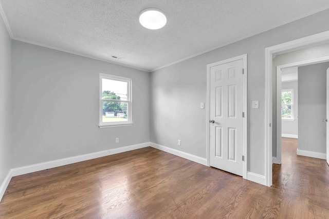 3010 Georgetown Dr NW, Cleveland, TN 37312 - unfurnished bedroom featuring a textured ceiling, wood finished floors, and ornamental molding