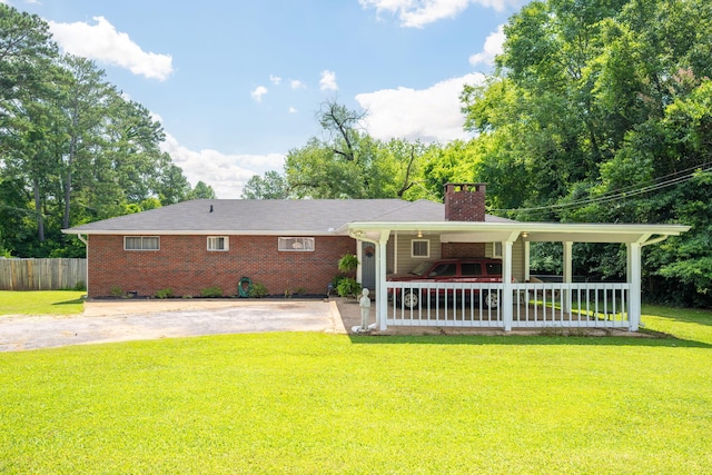 1318 Joiner Rd, Chattanooga, TN 37421 - view of front of home featuring a chimney, concrete driveway, brick siding, and a patio