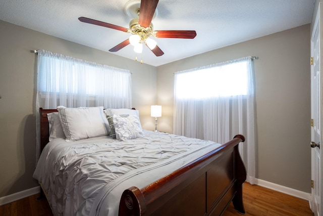 1318 Joiner Rd, Chattanooga, TN 37421 - bedroom featuring multiple windows, wood finished floors, and a ceiling fan