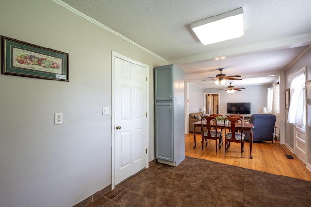 1318 Joiner Rd, Chattanooga, TN 37421 - dining space featuring crown molding, dark tile patterned floors, and a ceiling fan
