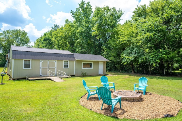 1318 Joiner Rd, Chattanooga, TN 37421 - rear view of house with an outdoor fire pit, a lawn, and an outbuilding
