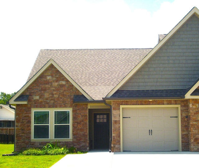 81 Morning Mist Dr, Rossville, GA 30741 - view of front of home with driveway, a shingled roof, stone siding, and a garage