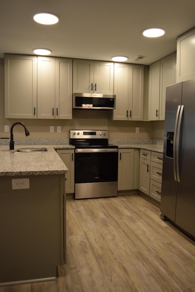 81 Morning Mist Dr, Rossville, GA 30741 - kitchen featuring stainless steel appliances, ventilation hood, light stone countertops, and light wood-style flooring