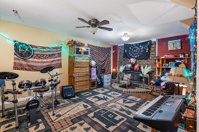 144 Bible Dr, Benton, TN 37307 - recreation room with a wood stove and ceiling fan