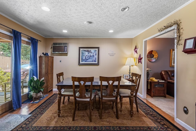 144 Bible Dr, Benton, TN 37307 - dining area with crown molding, a textured ceiling, wood finished floors, recessed lighting, and an AC wall unit