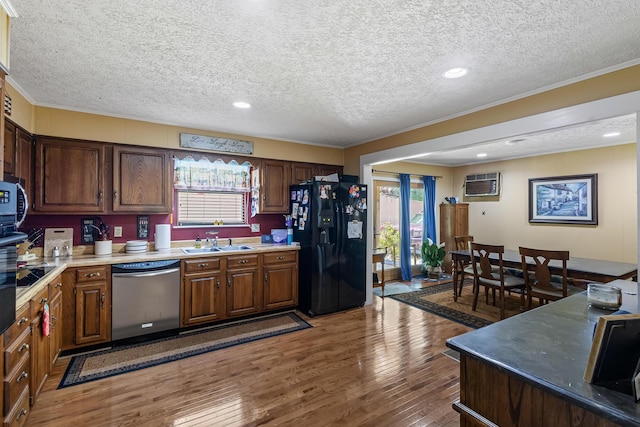 144 Bible Dr, Benton, TN 37307 - kitchen with stainless steel dishwasher, black fridge, ornamental molding, a wall mounted air conditioner, and a textured ceiling