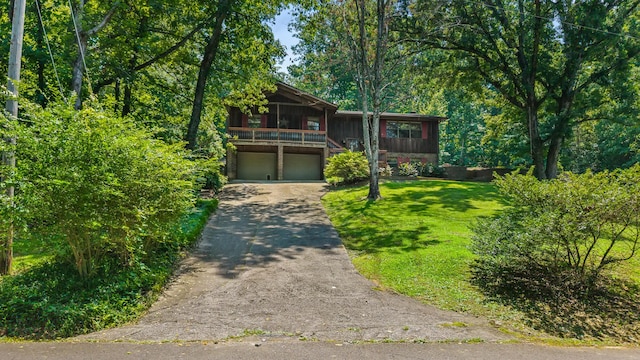 144 Bible Dr, Benton, TN 37307 - view of front of house with a garage, a front yard, asphalt driveway, and board and batten siding