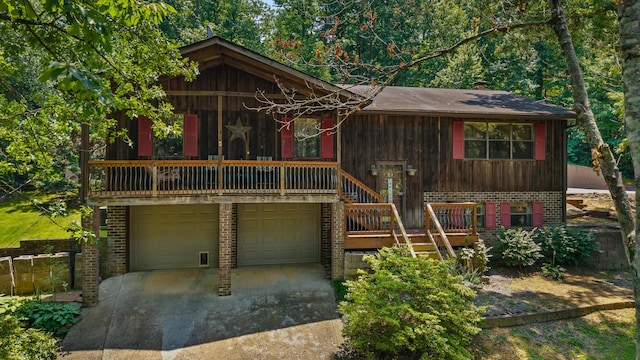 144 Bible Dr, Benton, TN 37307 - view of front of property featuring brick siding, concrete driveway, an attached garage, and stairway