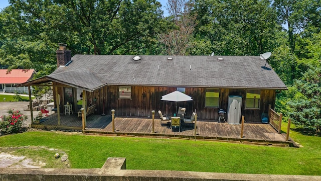 144 Bible Dr, Benton, TN 37307 - back of house featuring board and batten siding, a chimney, a deck, and a yard