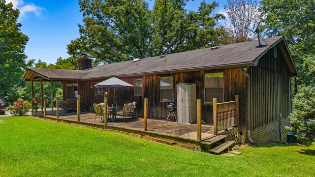 144 Bible Dr, Benton, TN 37307 - rear view of house featuring a chimney, a yard, a wooden deck, and a shingled roof