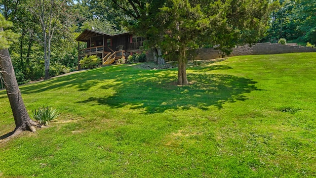 144 Bible Dr, Benton, TN 37307 - view of green lawn featuring stairs and a wooden deck