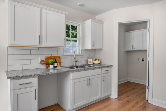812 Aubrey Ave, Chattanooga, TN 37411 - kitchen with decorative backsplash, light wood-type flooring, light stone counters, and white cabinetry