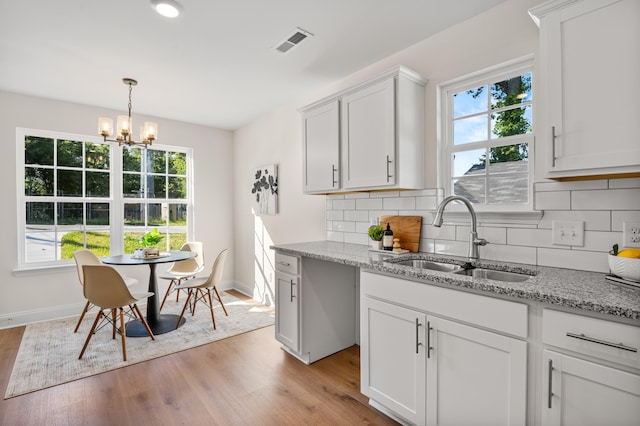812 Aubrey Ave, Chattanooga, TN 37411 - kitchen with healthy amount of natural light, light wood-style floors, and light stone countertops