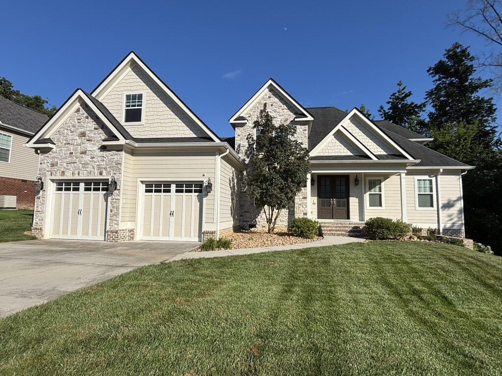 4138 Lone Elm Ln, Apison, TN 37302 - craftsman-style house featuring concrete driveway, a front lawn, and stone siding