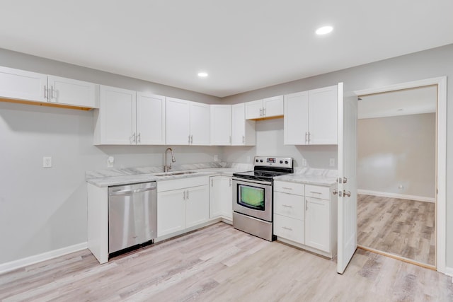 4212 Rogers Rd, Chattanooga, TN 37411 - kitchen featuring stainless steel appliances, light wood finished floors, white cabinets, light stone counters, and recessed lighting