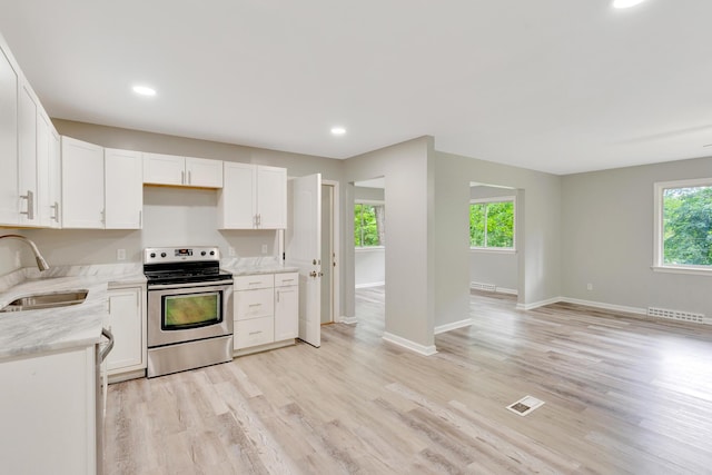 4212 Rogers Rd, Chattanooga, TN 37411 - kitchen with electric stove, light wood-style floors, white cabinets, and recessed lighting