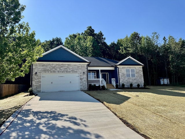 179 Burnt Hollow Trl SE, Cleveland, TN 37323 - ranch-style house featuring stone siding, concrete driveway, a garage, and a porch