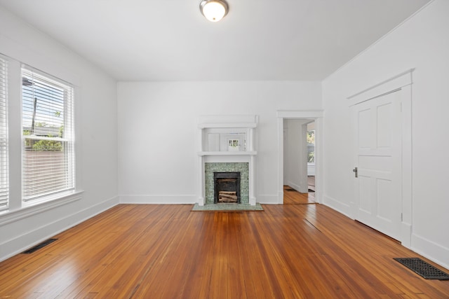 1306 Bailey Ave, Chattanooga, TN 37404 - unfurnished living room with plenty of natural light, a fireplace, and hardwood / wood-style floors