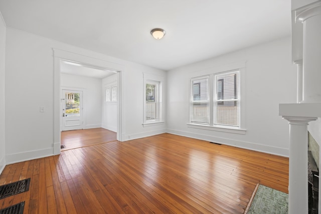 1306 Bailey Ave, Chattanooga, TN 37404 - unfurnished living room with hardwood / wood-style flooring and ornate columns