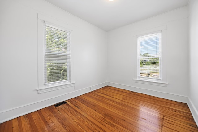 1306 Bailey Ave, Chattanooga, TN 37404 - empty room with healthy amount of natural light and wood finished floors