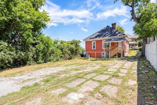1306 Bailey Ave, Chattanooga, TN 37404 - back of property featuring a chimney, roof with shingles, and stairway