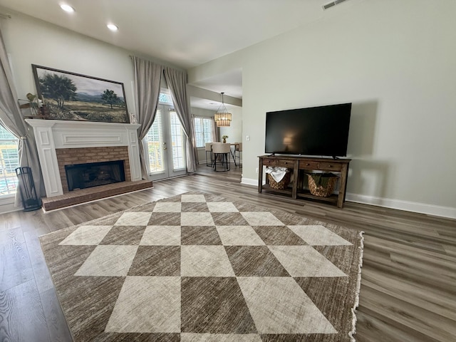 120 Oakhurst Ter NE, Calhoun, GA 30701 - unfurnished living room featuring wood finished floors, recessed lighting, a chandelier, and a fireplace