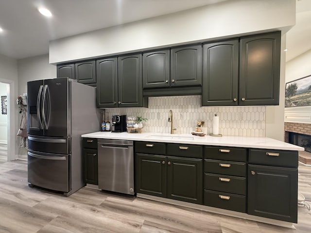 120 Oakhurst Ter NE, Calhoun, GA 30701 - kitchen with stainless steel appliances, light wood finished floors, light countertops, and tasteful backsplash