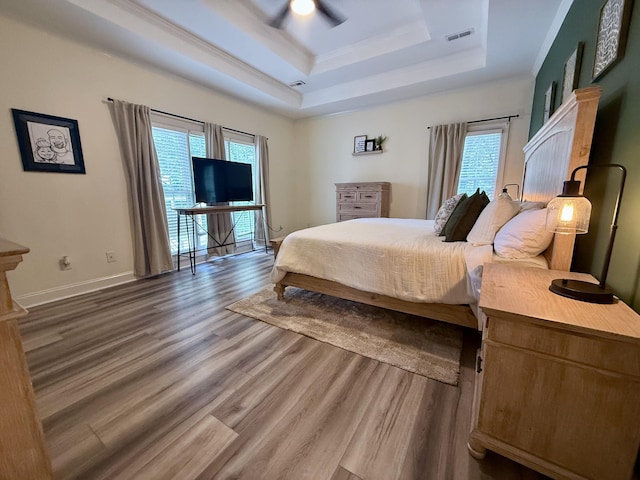 120 Oakhurst Ter NE, Calhoun, GA 30701 - bedroom featuring a tray ceiling, wood finished floors, multiple windows, a ceiling fan, and crown molding