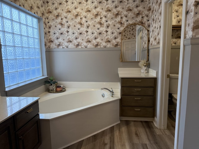 120 Oakhurst Ter NE, Calhoun, GA 30701 - full bath with wallpapered walls, a wainscoted wall, a bath, wood finished floors, and vanity
