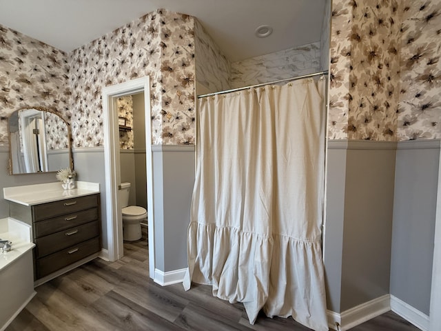 120 Oakhurst Ter NE, Calhoun, GA 30701 - bathroom with vanity, a shower with curtain, wallpapered walls, wood finished floors, and a wainscoted wall