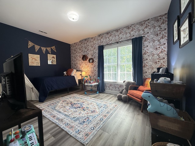 120 Oakhurst Ter NE, Calhoun, GA 30701 - bedroom with wallpapered walls, an accent wall, and wood finished floors