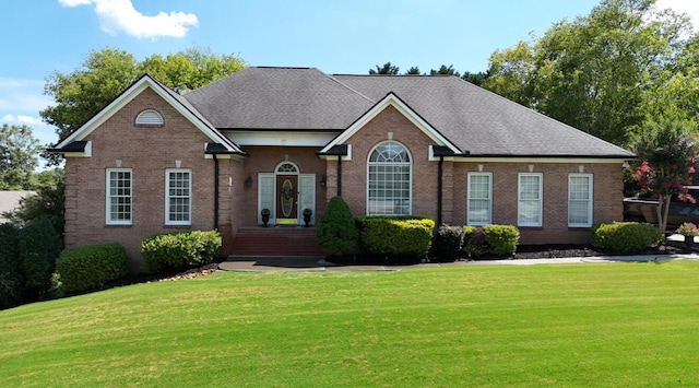 120 Oakhurst Ter NE, Calhoun, GA 30701 - view of front facade with a front lawn, brick siding, and roof with shingles